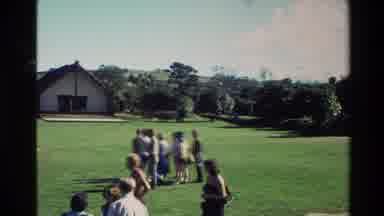 New Zealand (1981): People In The Field Of Grass Talking And Smiling