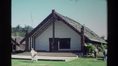 New Zealand (1981): House On Stilts And A Small Crowd Strolling Across Lawn