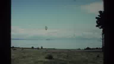 New Zealand (1981): Video Pans Left Looking At A Plain And A Distant Island In The