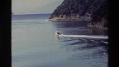 New Zealand (1982): Seagull Flying And Motorboat Skimming On Lake Waters On A