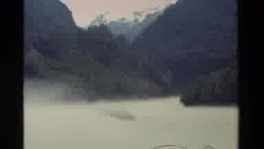 New Zealand (1982): Pan Of Mountains And Forest Showing Snow Capped Peaks In The