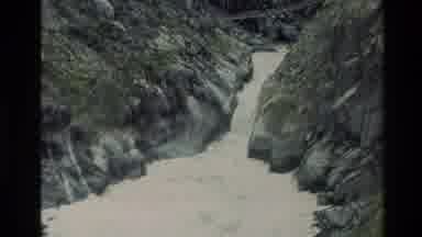 New Zealand (1982): A Footbridge Made Out Of Wood Over A River That Is Very Fast