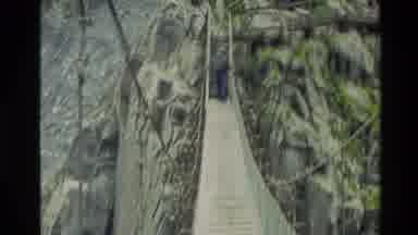 New Zealand (1982): Man Walking Across A Suspension Bridge Then Shows Fast Moving