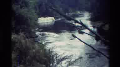 New Zealand (1982): Ice Stuck In A Flowing River From A Lake With Mountains In The