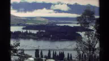 New Zealand (1982): Many People Gathered In A City With Many Forests And