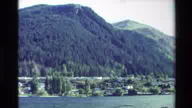 New Zealand (1982): Large Hills Near River With The Water Moving With Some Plants