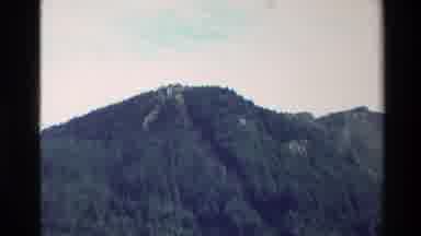 New Zealand (1982): At The Peak Of A Medium Sized Mountain Covered In Green Trees
