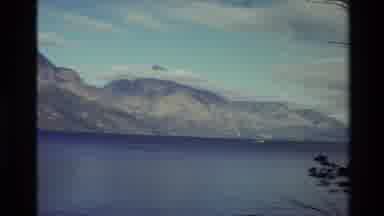 New Zealand (1982): Tugboats Setting Sail Along A Coast Of Mountains With Snowy