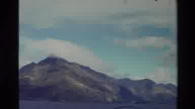 New Zealand (1982): Mountainous Landscape Crowned By White Fluffy Clouds While The