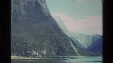 New Zealand (1982): Lush Mountains With Trees Near A Large Body Of Water