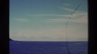 New Zealand (1982): Boats Moving Around The Island On An Open Sea On A Clear Day