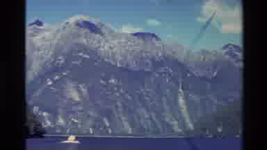 New Zealand (1982): Mountains From The Shore With A Boat Traveling Away
