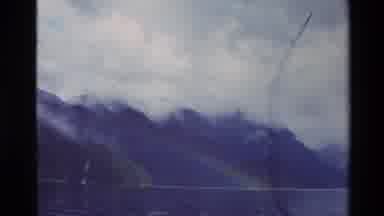 New Zealand (1982): Mist Covered Mountain Tops And A Lake Rainbow