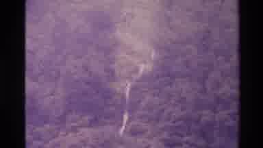 New Zealand (1982): Camera Shot Flying Over A River And A Green Jungle Forest