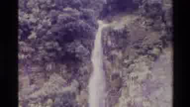 New Zealand (1982): Long Waterfall Falls Over A Cliff That Is Covered With Trees