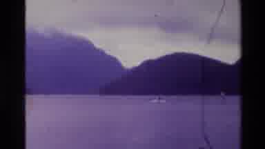 New Zealand (1982): Camera Shows Guy Surfing And Then Looks Up At Rainbow