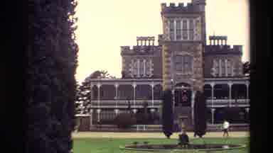New Zealand (1982): Person Leaving A Castle With A Large Front Lawn And Trees