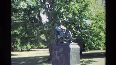 New Zealand (1982): Statue Stands Guard While Several People Explore A Greenhouse