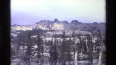 Big Sur California USA (1980): Snowy Mountain Scene With A Cloudy Sky And Pine