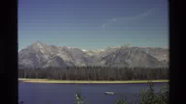Grand Teton Wyoming USA (1980): Motorboat Skimming Lake Waters Mountains And Trees