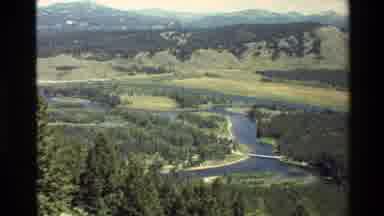 Grand Teton Wyoming USA (1980): Valley Surrounded By Mountains And Tall Trees With