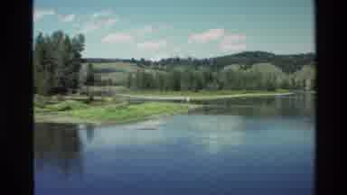Grand Teton Wyoming USA (1980): A Serene Still Lake Ornamented By Trees On A Sunny