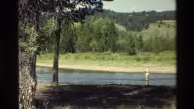 Grand Teton Wyoming USA (1980): Man Wearing Hat Fly Fishing In A Quiet Stream In A