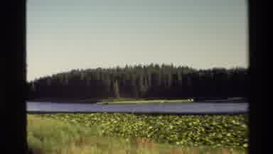 Grand Teton Wyoming USA (1980): Camera Zooming Out On Landscape With Body Of Water