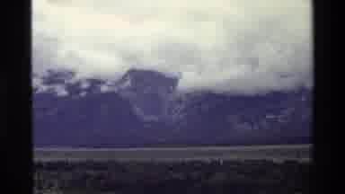 Grand Teton Wyoming USA (1980): Mountain Range Surrounded By Cloud Cover Behind A