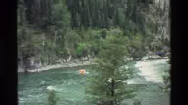 Grand Teton Wyoming USA (1980): An Orange Boat Sailing With A Slow Current Blue