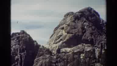 British Columbia USA (1981): Zooming Out Of Two Rocky Peaks On A Wood And Grass