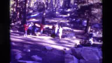 British Columbia USA (1981): Many People Walking Around Outside In Woods Red