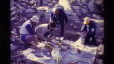 British Columbia USA (1981): People Setting Up Picnic Spread On A Bright Sunny Day