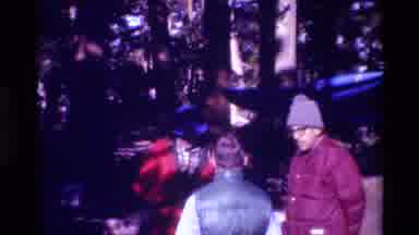 British Columbia USA (1981): People Wearing Hats Standing Talking Next To Blue