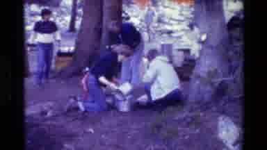 British Columbia USA (1981): People Pouring Water Out Of Pots Outside In The Woods