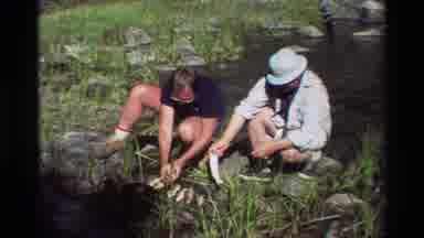 British Columbia USA (1981): Two People Catching Fish From Wild Stream