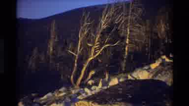 British Columbia USA (1981): Sun Shining Through Clouds Onto Rocky Terrain
