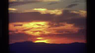 British Columbia USA (1981): A Beautiful Sunset And Two People Hiking Over A Rocky