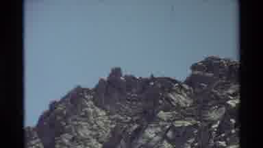 British Columbia USA (1981): Man Jumping Between Rocks On A Sunny Day And A