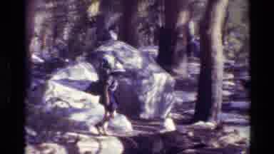British Columbia USA (1981): Woman With Camping Backpack Hikes Alone Around Trees
