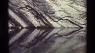 British Columbia USA (1981): Doom In Of Stony Cliff Side Next To Body Of Water