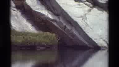 British Columbia USA (1981): Rock Outcropping Above Water With Small Grassy Island