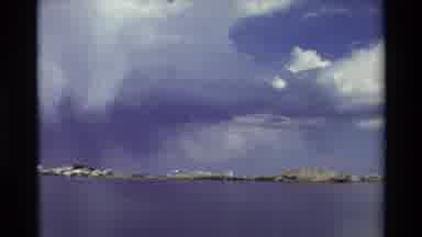 British Columbia USA (1981): Cumulus Clouds Over Clear Mountain Lake In The Summer