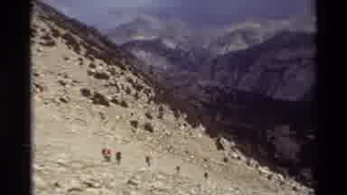 British Columbia USA (1981): People Walking Down On A Rocky Mountain Toward A Body