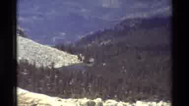 British Columbia USA (1981): Camera Zooms In On Mountain Pond Or Lake Surrounded