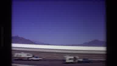 Western USA-1980: Car Park With Two Trailers With Open Doors And Rides In The