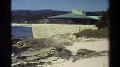 CARMEL CALIFORNIA USA-1982: Waves Crashing On A Beach To Nearby Building And