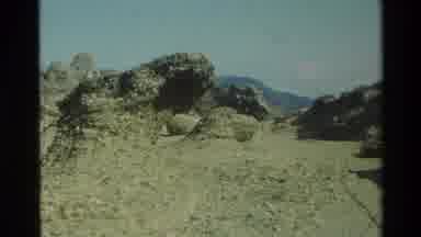 Carmel California USA (1982): People Walking Between Large Rocks On A Desert Or