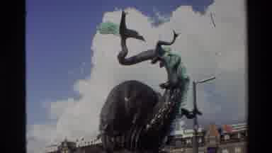 Denmark (1982): In An Urban Setting A Green Aged Creative Fountain Stands Tall In