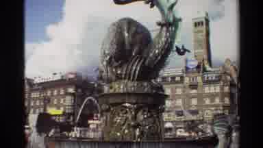 Denmark (1982): Looking Up At A Large Fountain With A Statue In A City